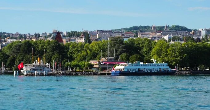 Lausanne, Switzerland - July 14, 2022: View from the moving tourist boat on Geneva lake at the city of Lausanne
