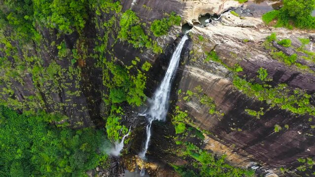 Tropical Diyaluma Falls in mountain jungle. Waterfall in the rainforest.
