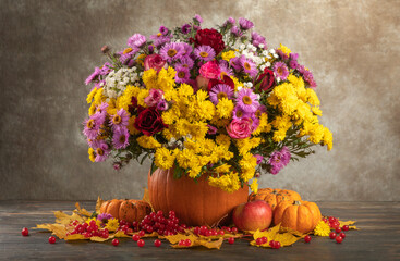 happy thanksgiving still life. autumn flowers roses, chrysanthemums, asters in a pumpkin vase - 552479404