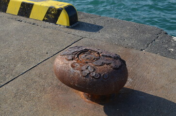 Close-up of rusty old pole on a quay.