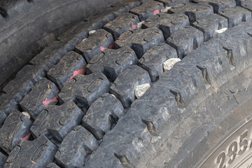 Tire tread on heavy duty grain truck tires. Treadwear, tire inspection, maintenance and safety concept.