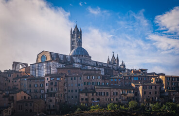 Fototapeta na wymiar Beautiful panoramic view of the historic city of Siena at the morning with an amazing cloudscape on an idyllic autumn evening, Tuscany, Italy. October 2022