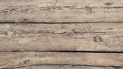 old wood texture surface view from closeup for a background - blank notched wooden board from a rough rural table in litgh brown color