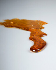 golden brown cannabis wax smear closeup texture