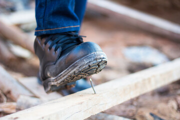 Wear safety shoes to ensure safety at work. construction workers wear safety shoes. concept construction workers work on the stairs