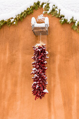 Christmas scene of snow-covered red chile ristra in Santa Fe, NM
