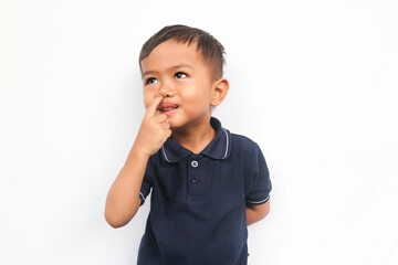 Toddler boy pick your nose or picking a booger on white background