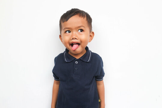 Adorable small child showing his tongue isolated on a white background