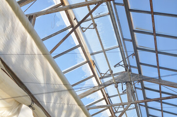 Greenhouse roof on a sunny day.With open curtains. ビニールハウス