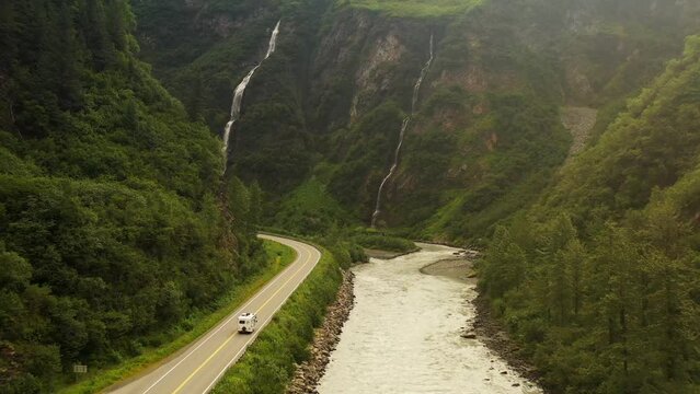 Van driving through waterfalls in Keystone Canyon, Valdez, Alaska