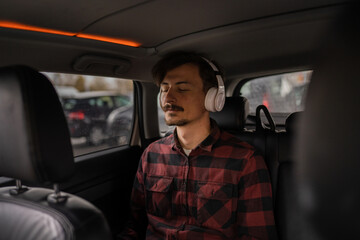 one man with headphones sit in the car listen guided meditation