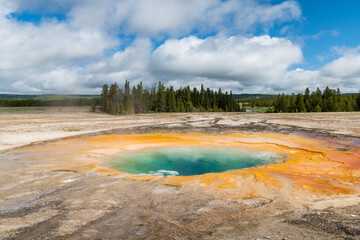 Opal Pool and landscape under a dramatic sky in Yellowstone