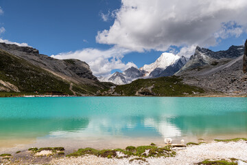 Sky reflection through the surface of the stunning Milk sea in Daocheng Yading, Sichuan, China. Because of its unique landform and original natural scenery, it is regarded as "the last pure land"