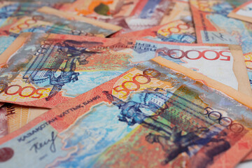 Background with paper banknotes of Republic of Kazakhstan. 5000 Kazakh tenge. Cash to pay for purchases. Money for travel, tourism, adventure. Currency exchange before the trip. Salary, loan repayment