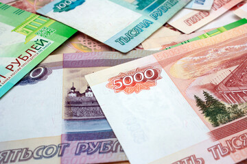 Background photo with Russian purple, red, green money. Paper cash banknotes of Russia. 5000 rubles. Ruble. Concept of payment for purchases, credit, debt. Financial crisis. Increase in cost of bill