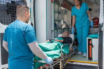 Doctor and nurse taking a patient out of an ambulance
