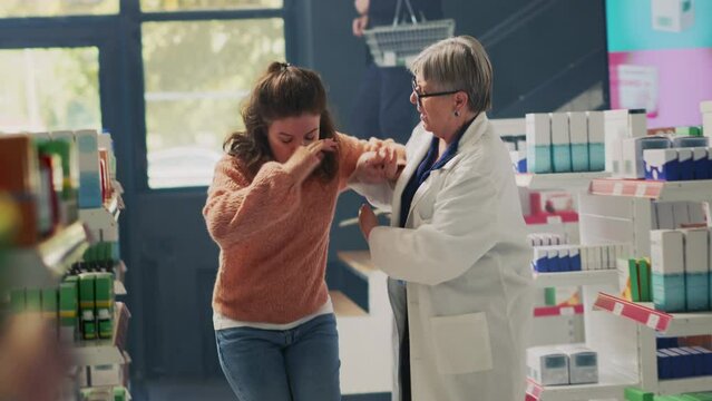 Young customer fanting in drugstore and feeling off, almost falling down and having vertigo sensation. Woman losing consciousness and balance near shelves, asking for assistance. Dutch angle.