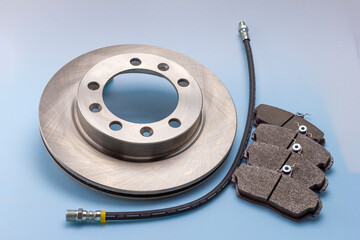 automotive brake parts and components for completing mechanisms and repairing a car on a white-blue milky background.