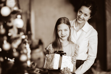 happy mom and her daughter with a Christmas gift. black and white photo