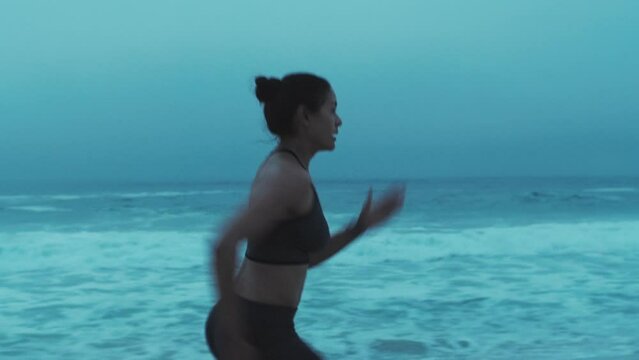 Runner woman, fast sprinter and beach training on winter morning, outdoor and workout for health. Athlete exercise, speed running and time goals for contest, race or competition by ocean in Naples