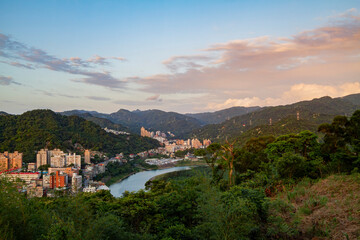 Fototapeta na wymiar Sunset aerial view of the Xindan District cityscape from Hemei Mountain