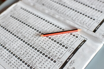 Maths workbook on table in classroom with pencil