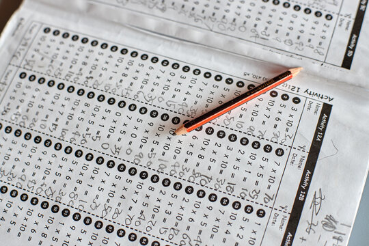 Maths workbook on table in classroom with pencil