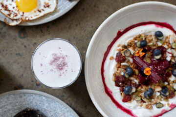 Healthy breakfast cereal with yoghurt and hot beverage