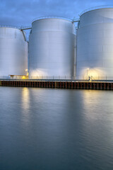 Big oil storage tanks at dusk seen in Berlin