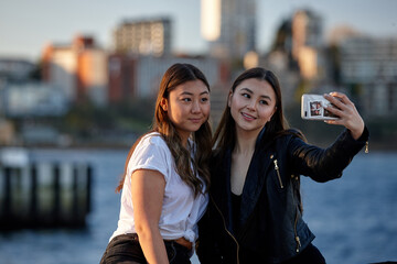 Two young women taking selfie by Sydney harbour