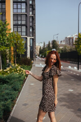 Young pretty trendy girl posing at the city in Europe