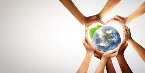 Conceptual symbol of multiracial human hands surrounding the Earth globe. Unity, world peace, humanity concept. World environment day- Earth Day concept. Elements of this image furnished by NASA.