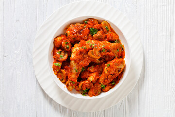 chicken stew with mushrooms in a tomato sauce