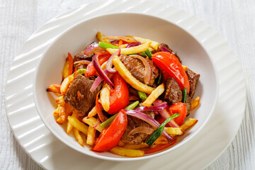 Lomo saltado, fried beef, french fries, veggies