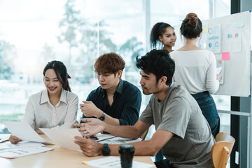Fototapeta na wymiar Young asian people having business meeting in office. teamwork brainstorming planning meeting concept
