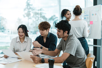 Fototapeta premium Young asian people having business meeting in office. teamwork brainstorming planning meeting concept