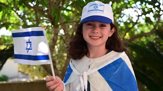 Happy Israeli Jewish Girl (age 08) With Israel Flag On Israel Independence Day (Yom Haatzmaut/Yom Hazikaron) Commemorating The Israeli Declaration Of Independence In 1948. Real People. Copy Space