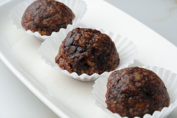 Three chocolate candies sweets on white plate