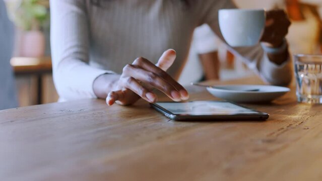 Woman, hands and digital tablet in coffee shop scroll on internet, website or reading online research for remote work. Female freelancer, cafe and technology, planning and mobile app for productivity