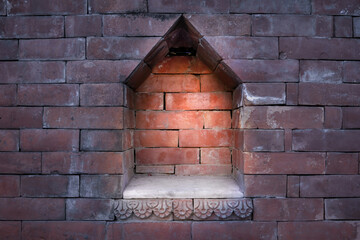 Illuminated empty alcove or indentation in a brick wall at night. Suitable as a stage for product...