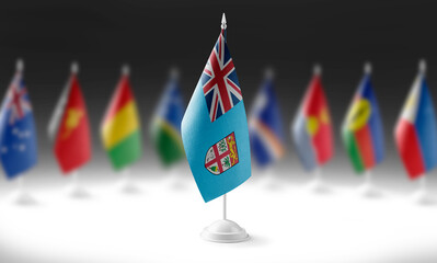 The national flag of the Fiji on the background of flags of other countries