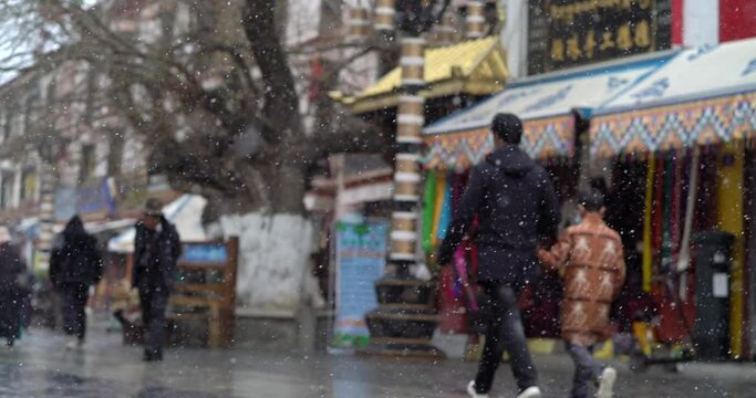 Tibet, Lhasa, China, People walking along the ancient Barkhor street Bakuo W street in summer day in cloudy we