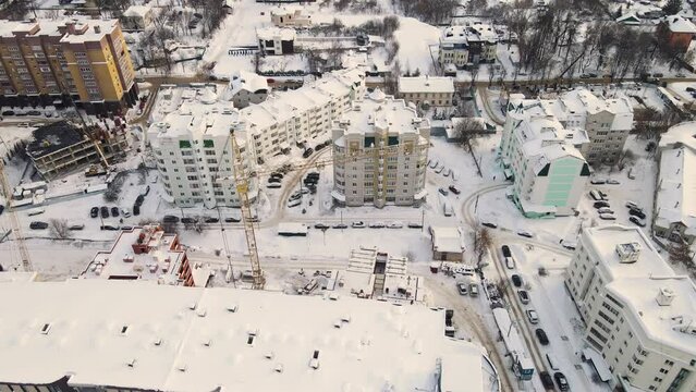 Bird's eye view of an urban residential area littered with snow. New buildings in a modern metropolis. Solution of the housing problem. City of Vladimir, Oktyabrsky district. UHD 4K.