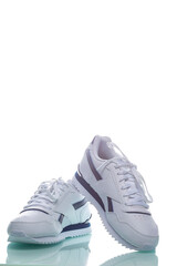 One Pair of New White Sneakers Over White Background.