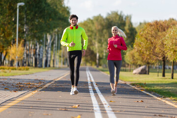 Sport Concepts. City Running Couple Happily Jogging Outside as Runners Training Outdoors Working Out in City As Fitness Couple.