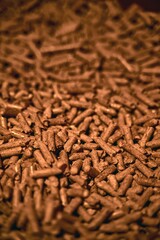 Close-up of stacked wood pellets. Detailed shot of woodpellets. Pellet texture