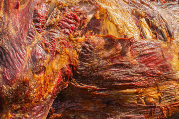 The muscular part of bull beef prepared on a spit in the outdoor food festival