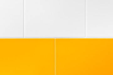 Close-up of white and yelllow ceramic decorative tiles for walls of kitchen, bathroom or toilet.