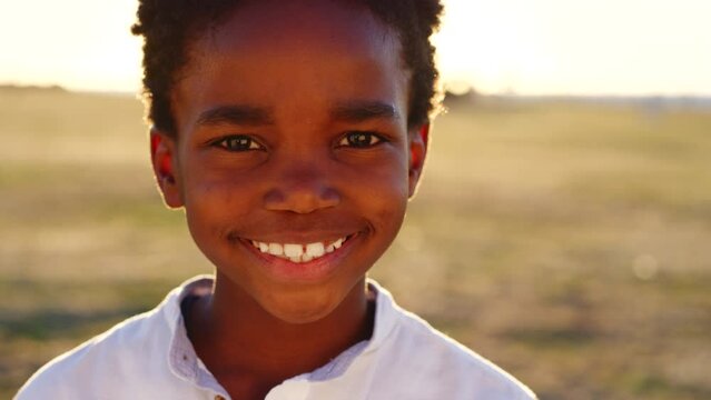Black child, boy and face at sunset in nature park, Congo garden or sustainability environment on school trip. Portrait, zoom and happy smile for kid, climate change accountability or responsibility