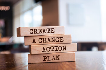 Wooden blocks with words 'Create a change action plan'.